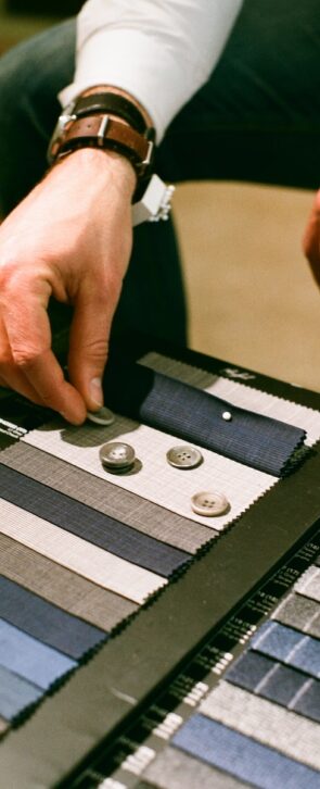 a man is working on a piece of cloth